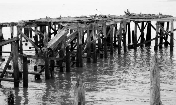 istock Dilapidated boat dock falling apart on the water 937150978