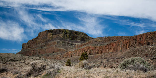 istock Red desert peak with a blue sky and scrub brush 937153206