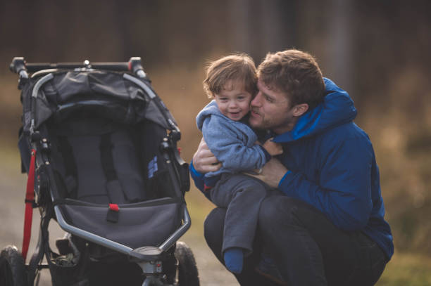 istock Dad Taking His Son for a Walk in the Stroller 937158876
