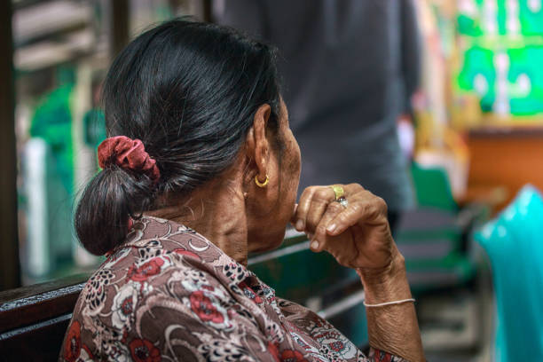 istock An old Asian woman looking at something 937161994