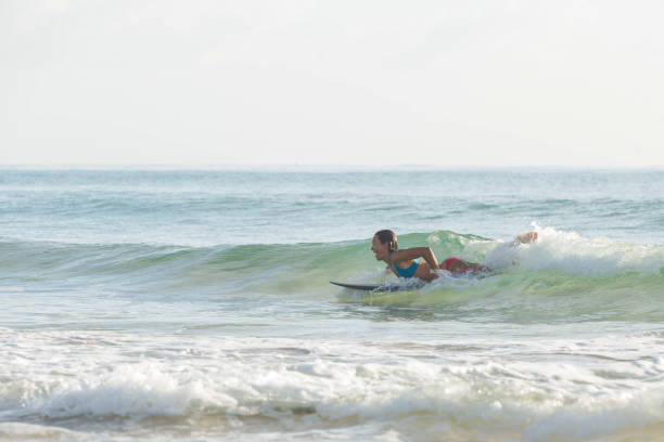 istock Woman surfing solo in Hawaii 937162006