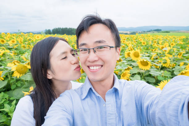 istock couple selfie with sunflower 937164616