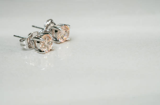 istock Closeup old diamond earring on blurred marble floor background 937164712