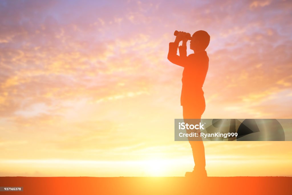 silhouette of businessman silhouette of business man take binocular telescope with sunset Opportunity Stock Photo