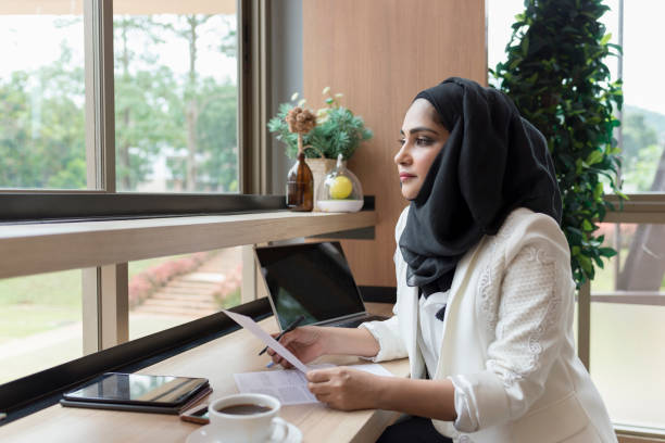 Arabian Businesswoman working in the coffee shop. Arabian Businesswoman working in the coffee shop. malaysia office workers stock pictures, royalty-free photos & images
