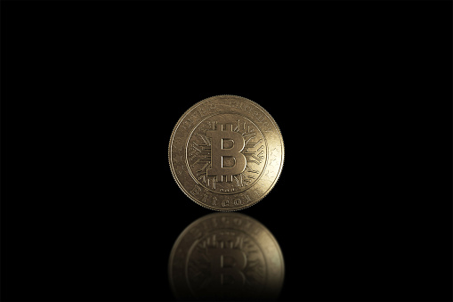 Gold coin Bitcoin on a black background. The concept of crypto currency. Blockchain technology.