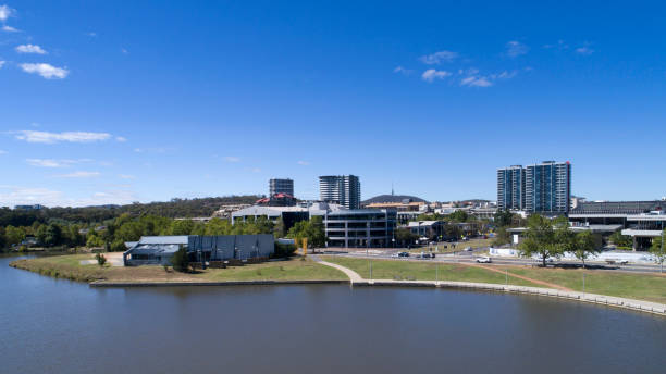 Aerial of buildings towards Belconnen from Lake Ginninderra High aerial viewpoint photographed by a DJI Phantom 4pro, looking towards buildings  and cars moving around, a few people in the distance, Telstra tower in the background and Westfield belconnen mall to the right and belconnen gallery to left on a nice sunny day. belconnen stock pictures, royalty-free photos & images