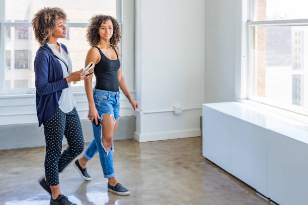 istock Young Women Inspecting a Modern Apartment or Office 937182610