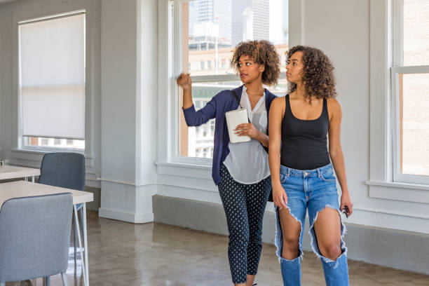 istock Young Women Inspecting a Modern Apartment or Office 937182612