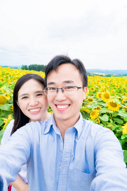 istock couple selfie with sunflower 937186882