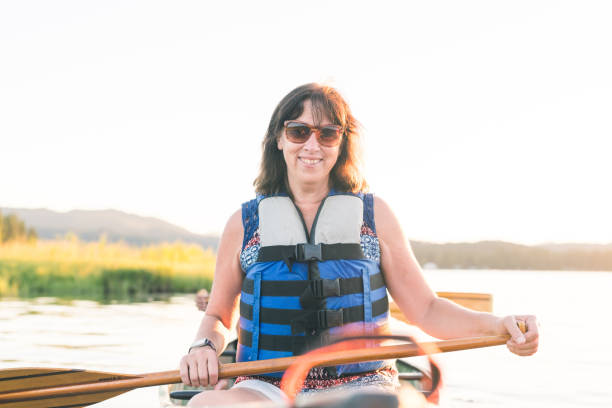 istock Older couple canoe together on a lake 937207042