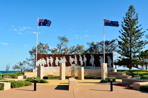 Emu Park, Queensland, Australia -  December 27, 2017. Anzac Court Memorial at beach front in Emu Park, Queensland, Australia, with flags and trees.
