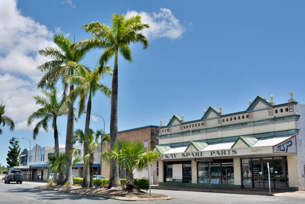 Street view in Mackay, QLD Mackay, Queensland, Australia - December 28, 2017. Street view in Mackay, QLD, with historic art deco buildings, commercial properties, car and palm trees. mackay stock pictures, royalty-free photos & images