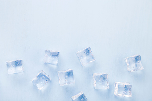 Ice cubes on a blue background. Concept of diet.  Diet for weight loss.