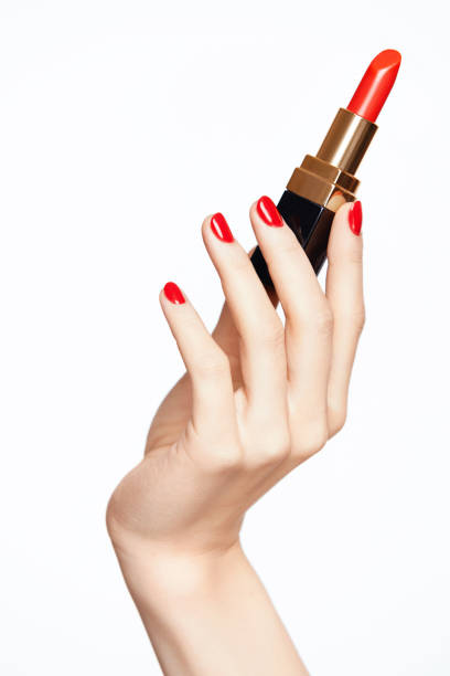 istock Woman Hand With Red Nails Holding Red Lipstick 937210468