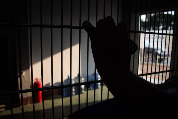 istock hand of prisoner in jail 937210840
