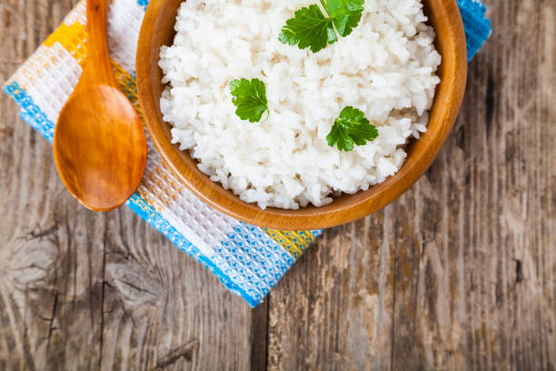 istock Boiled rice in a wooden bowl and spoon 937213124