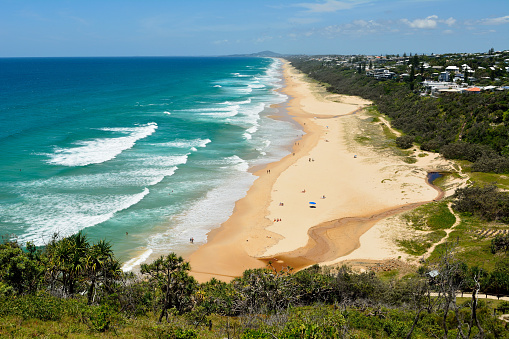 Seascape of water waves flowing over rocks at the beach on a perfect, clear sunny day. Photographed in Australia.