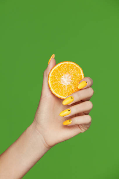 istock Nails Design. Hands With Fashion Manicure Holding Orange 937221184