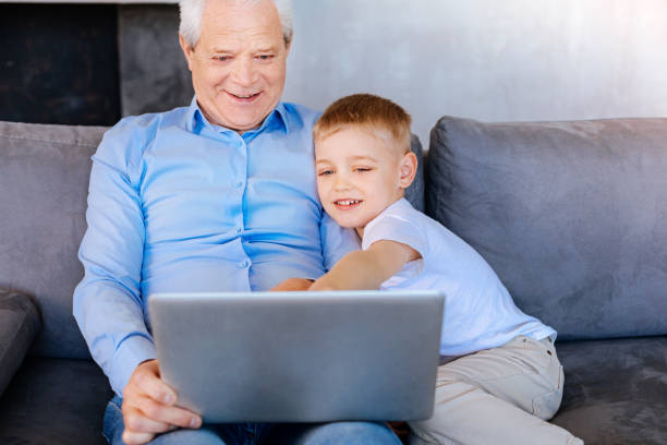 istock Joyful cute boy pointing at the laptop screen 937222442