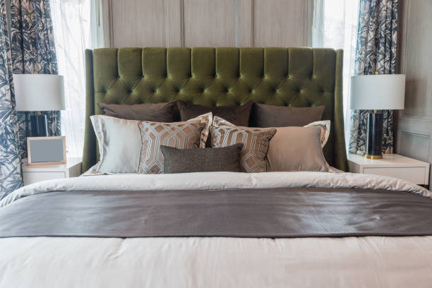 istock Many pillow on a bed with a blanket and lamp side a bed. 937222472