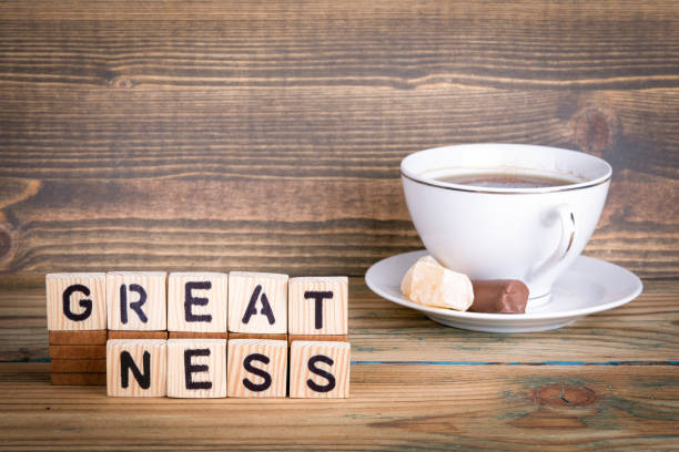 istock greatness. Wooden letters on the office desk, informative and communication background 937224924