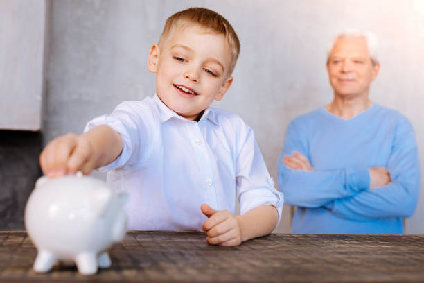 istock Positive cute boy saving money 937225588