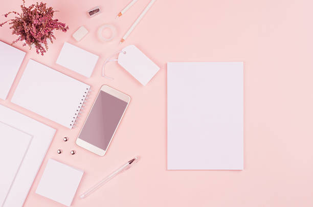 istock Modern minimalistic spring workspace with white blank stationery on soft pastel pink background, top view, copy space. 937234224