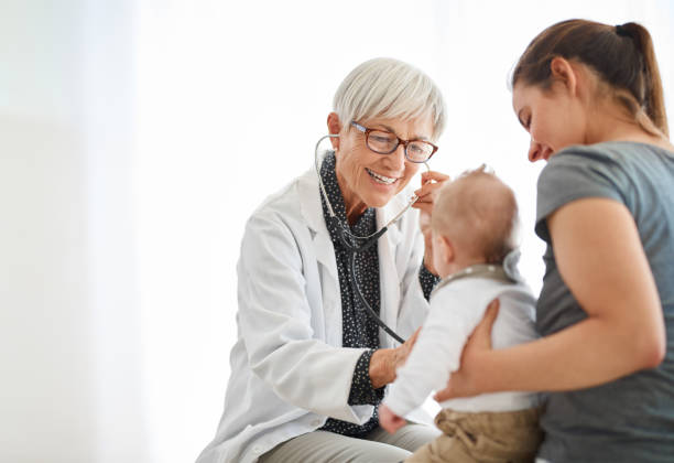 That's a strong heartbeat! Shot of a young mother taking her baby daughter for a checkup at the doctor’s office pediatrician stock pictures, royalty-free photos & images