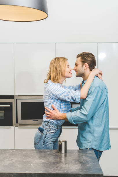istock side view of affectionate couple hugging each other at home 937245638