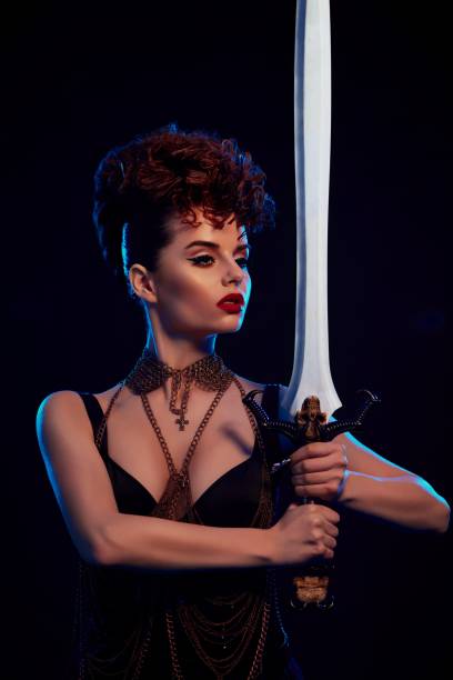 istock Brave warrior woman keeping big steel sword. 937248934