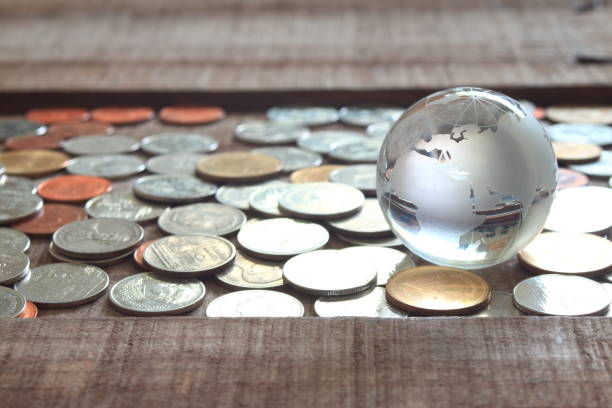 istock Map world glass on coins , finicial concept. 937249658