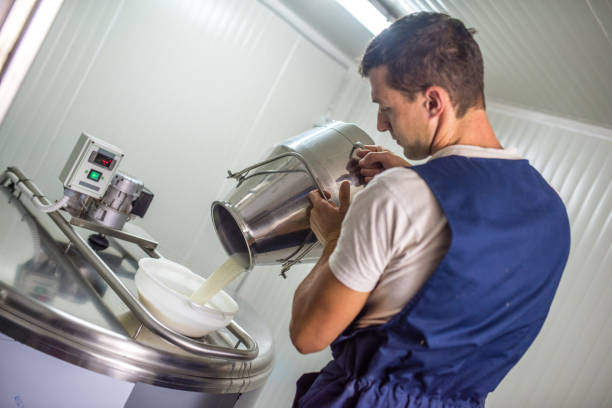 istock Veterinarians pouring milk into tank 937254044