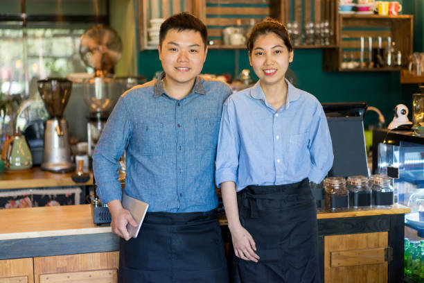 istock Cheerful coffee shop staff working together 937256310