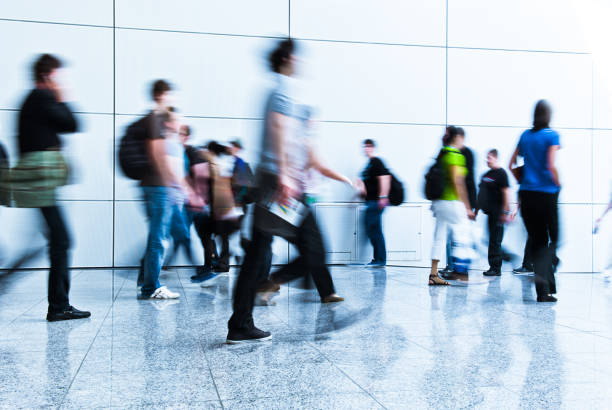 istock blurred crowd of people 937257724