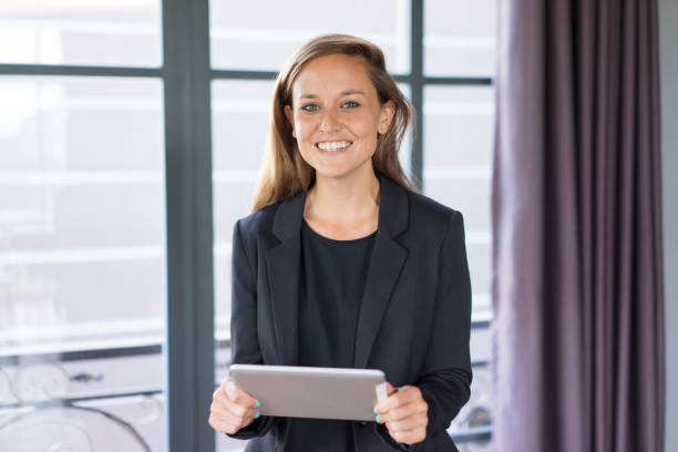 istock Happy Business Woman Using Tablet at Window 937260694