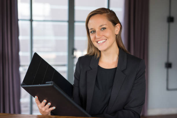 istock Smiling Business Woman with Folder in Lobby 937260924