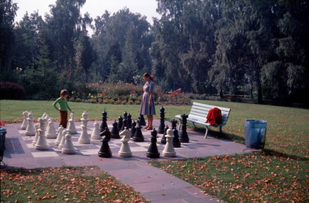 Strandbad Wannsee, Berlin (West), Germany, 1976. Mother and son play together a game of chess in Strandbad Wannsee.