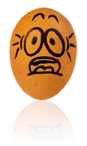 istock Easter egg, painted in a terrified cartoon funny face of a guy. Decorated scared egg in a natural yellow color. 937262856