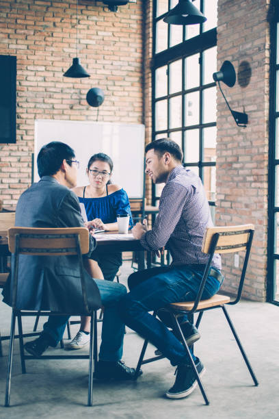 istock Business Team Discussing Strategy in Cafe 937265888