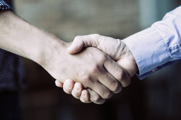 istock Closeup of Two Business Men Shaking Hands 937265898