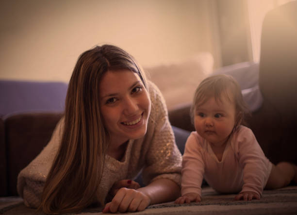 istock Smiling Mother With Baby Looking At Camera 937266154