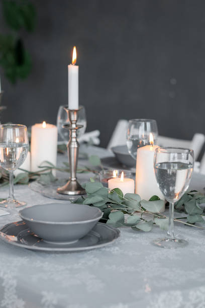 istock Wedding or festive table setting. Plates, wine glasses, candles and cutlery 937266472