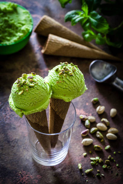istock Pistachio ice cream cones shot on rustic table 937269438