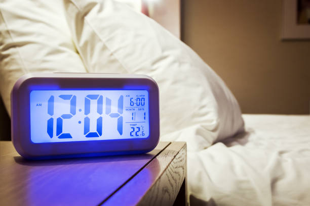 istock electronic alarm clock stands on a bedside table in the room 937270680