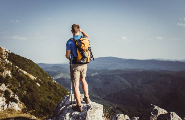 istock Young Man Standing on Top of Hill 937274478