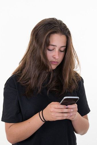 Woman wearing a black shirt using a mobile phone isolated on a white background