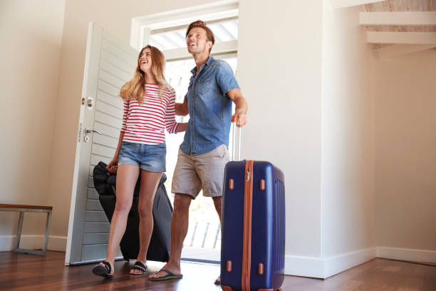 istock Couple Arriving At Summer Vacation Rental 937275778