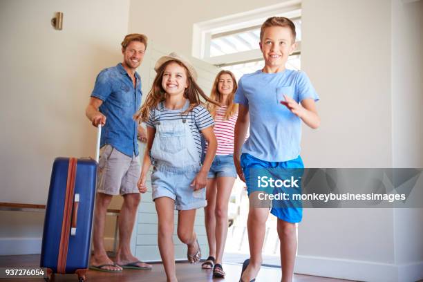 Family Arriving At Summer Vacation Rental Stock Photo - Download Image Now - Family, Hotel, Vacations