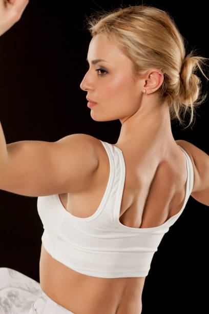 Beautiful sporty blonde posing on a black background